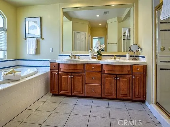 a spacious bathroom with a granite countertop sink and a mirror