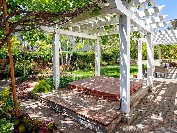 a view of backyard with plants and outdoor seating