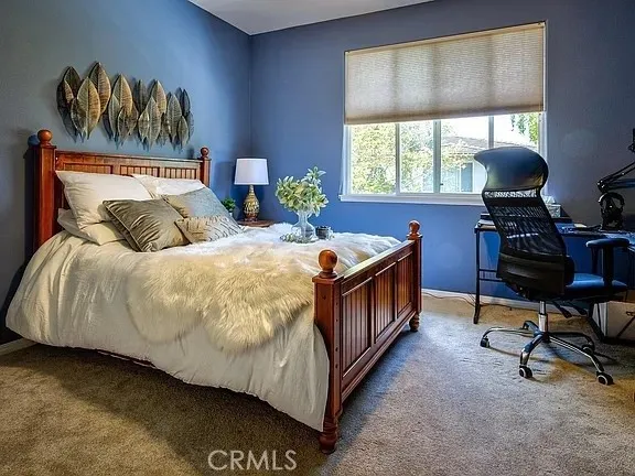 a living room with a bed furniture and a window