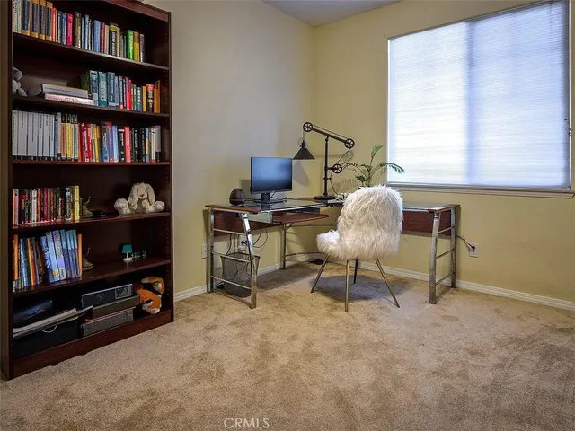 a living room with furniture and a book shelf