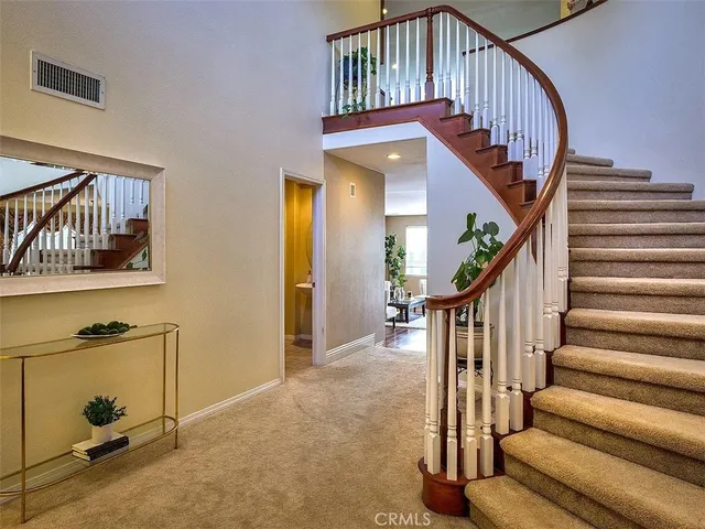 a view of entryway with wooden floor and a front door