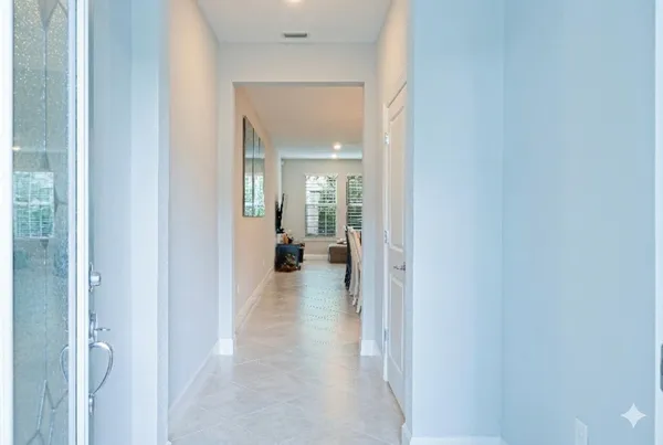 a view of a hallway with a view of living room and a bathroom