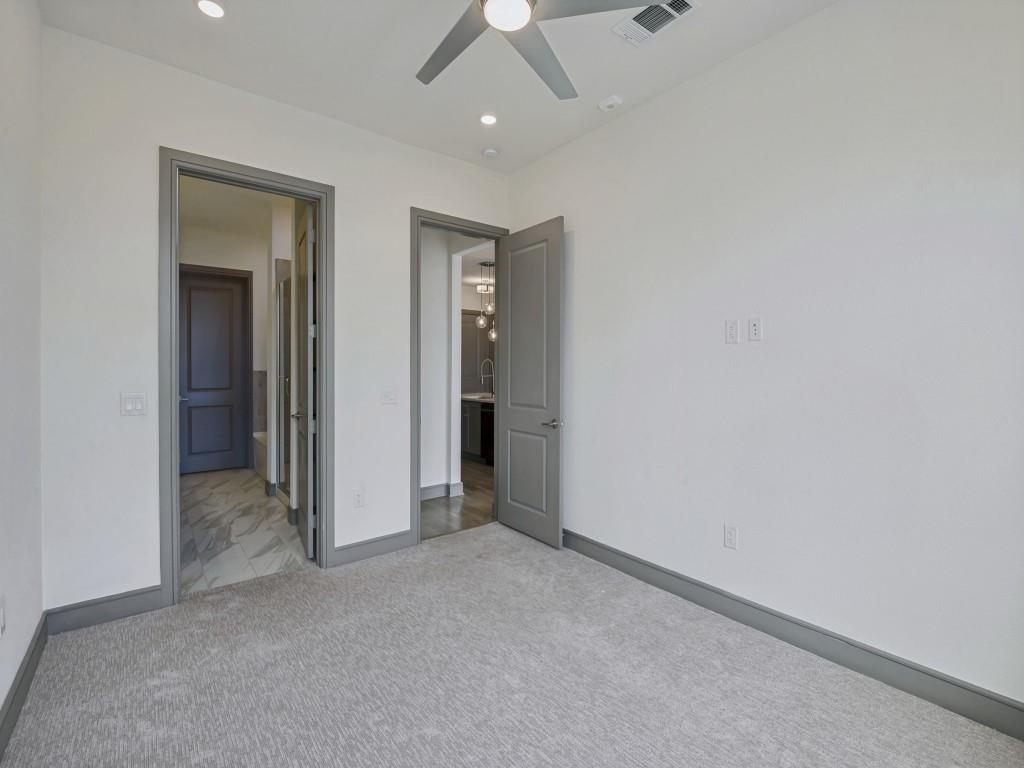 2700 Old Denton Road, Unit 4427 Carrollton, TX 75007 - Photo 13 of 25 an empty room with chandelier fan