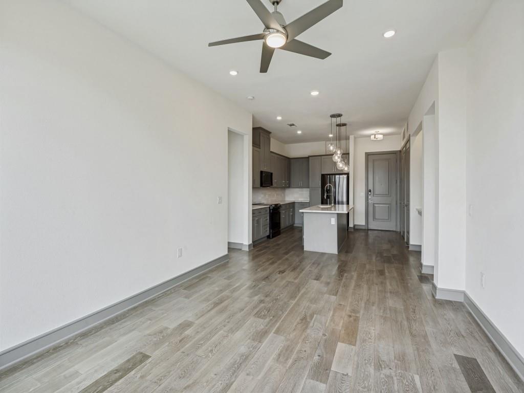 2700 Old Denton Road, Unit 4427 Carrollton, TX 75007 - Photo 2 of 25 a view of a kitchen with a sink and dishwasher a refrigerator with wooden floor