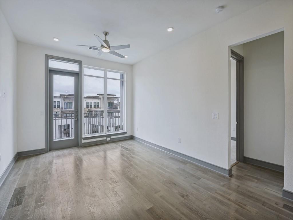 2700 Old Denton Road, Unit 4427 Carrollton, TX 75007 - Photo 5 of 25 a view of an empty room with wooden floor and a window