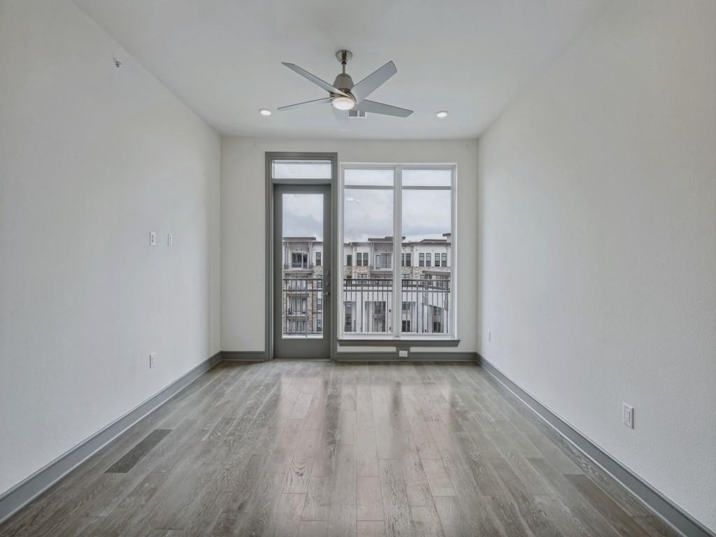 2700 Old Denton Road, Unit 4427 Carrollton, TX 75007 - Photo 6 of 25 wooden floor in an empty room with a window