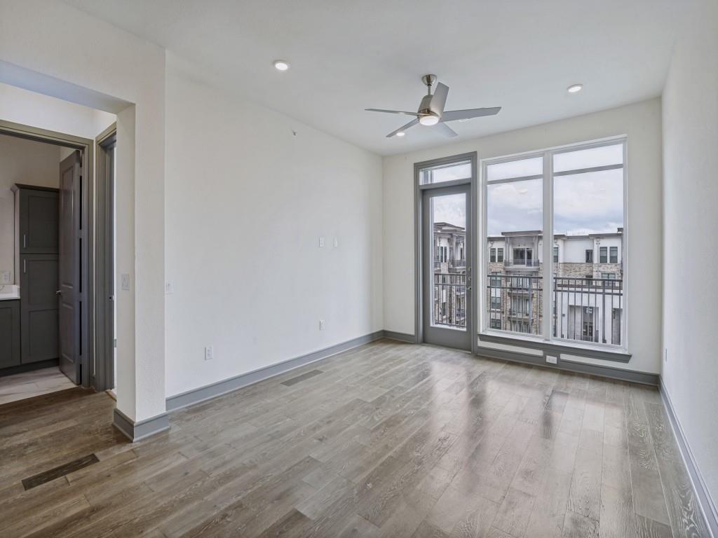 2700 Old Denton Road, Unit 4427 Carrollton, TX 75007 - Photo 7 of 25 a view of an empty room with wooden floor and a window