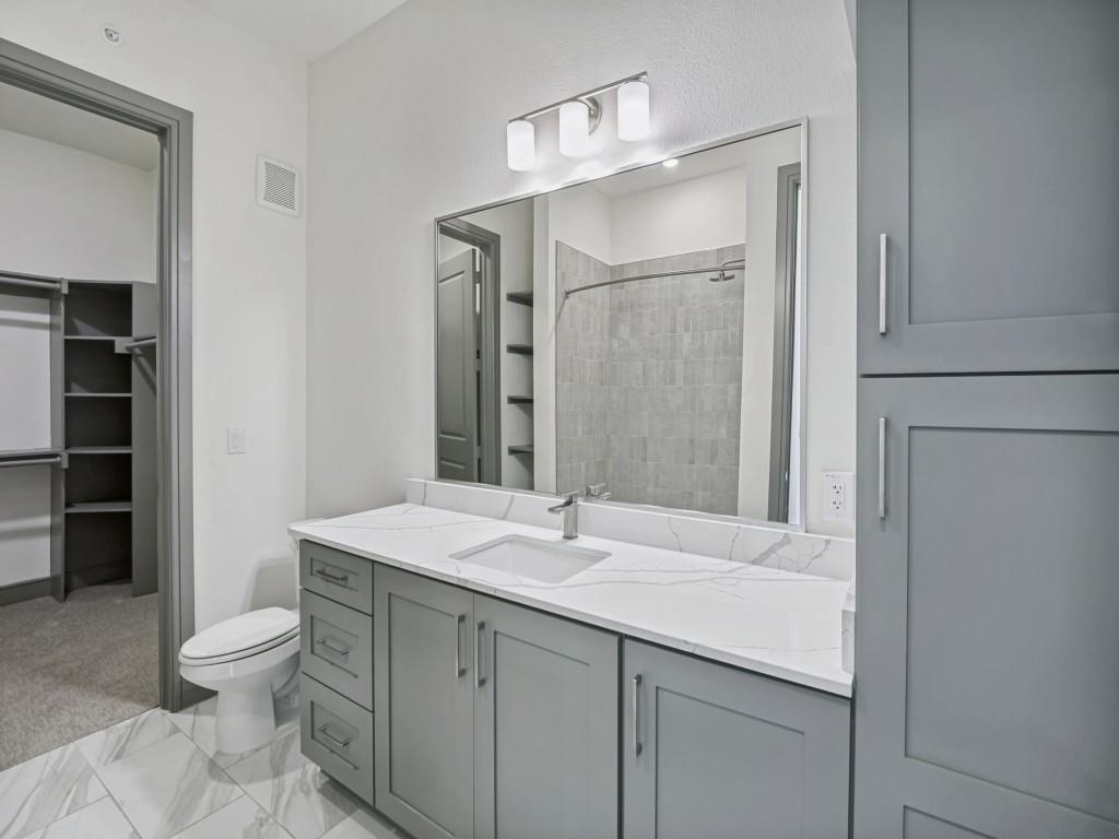 2700 Old Denton Road, Unit 4427 Carrollton, TX 75007 - Photo 9 of 25 a bathroom with a sink toilet and shower