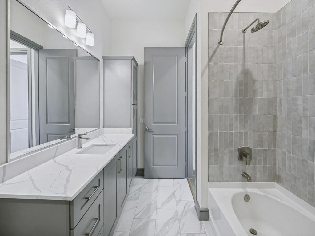 2700 Old Denton Road, Unit 4427 Carrollton, TX 75007 - Photo 10 of 25 a bathroom with a tub sink and mirror