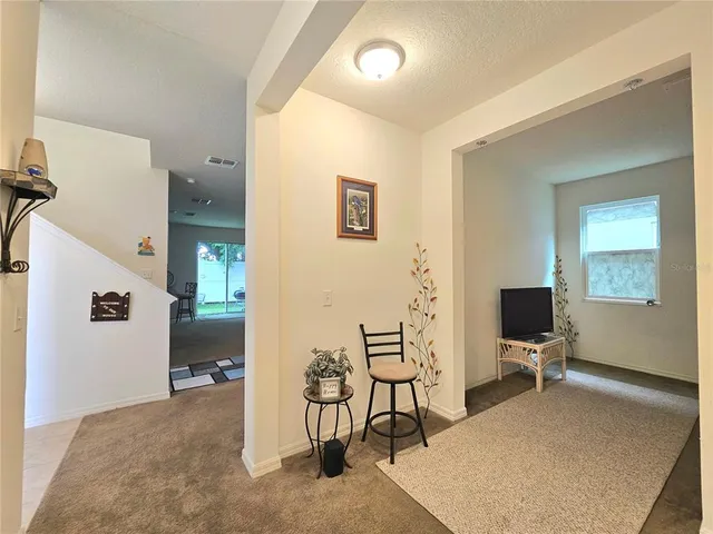 a view of a livingroom with furniture and a flat screen tv