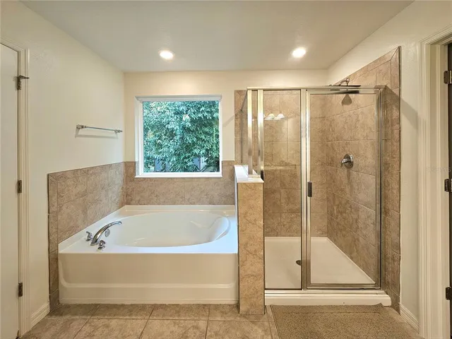a bathroom with a bathtub and a shower