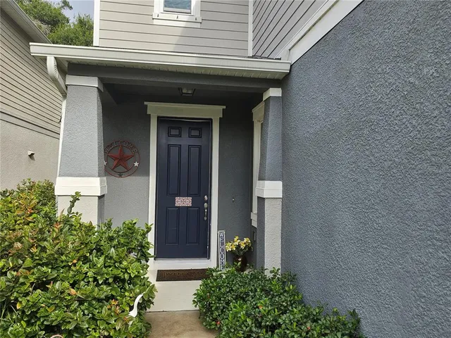a view of a house with potted plants