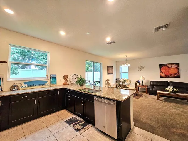 a kitchen with stainless steel appliances granite countertop a sink and a stove