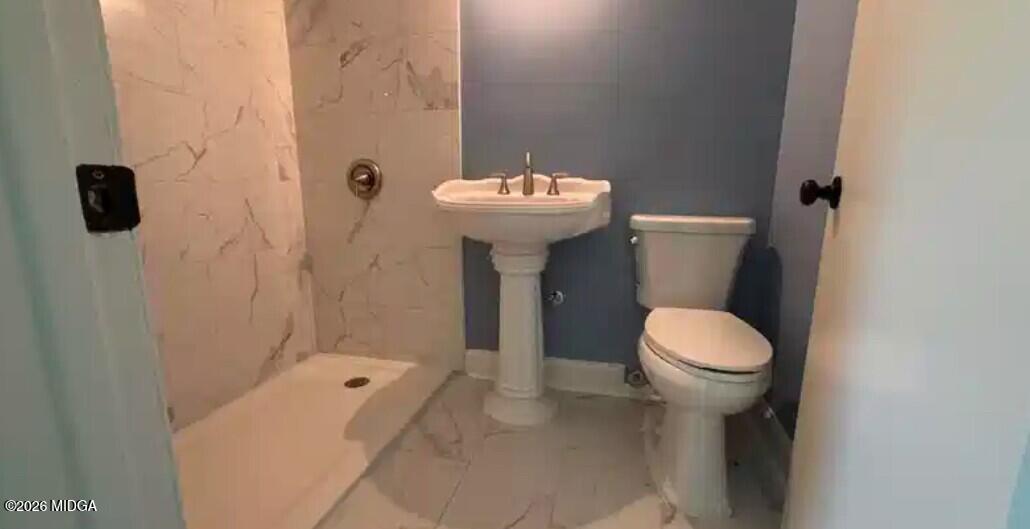 29 Dolly Lane Macon, GA 31217 - Photo 10 of 16 a bathroom with a sink a toilet and shower