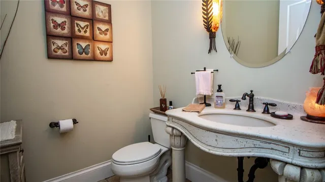 a front view of a house with a garden and trees