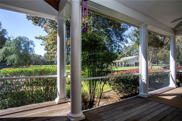 a bathroom with a tub a sink and a large mirror