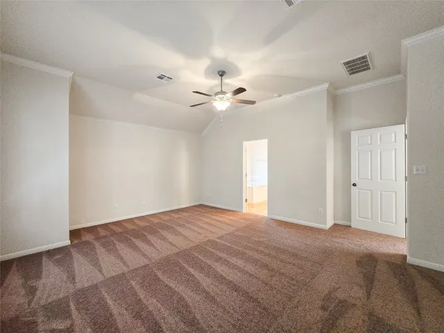 a view of an empty room with a ceiling fan