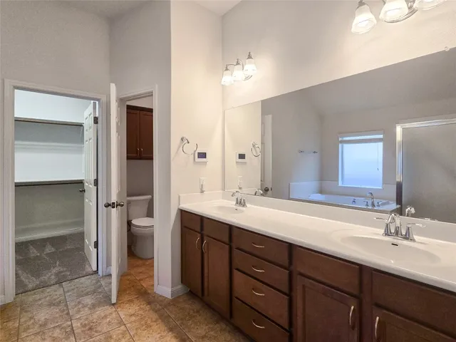 a bathroom with a double vanity sink and a mirror