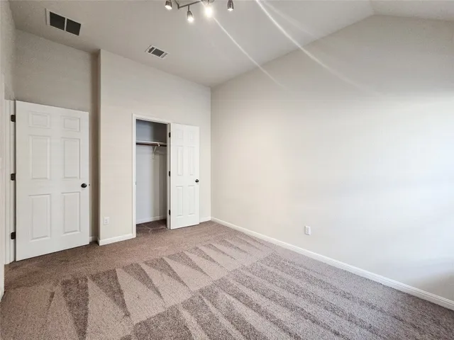 an empty room with a window and ceiling fan