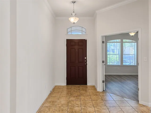 a view of a room with wooden floor and windows