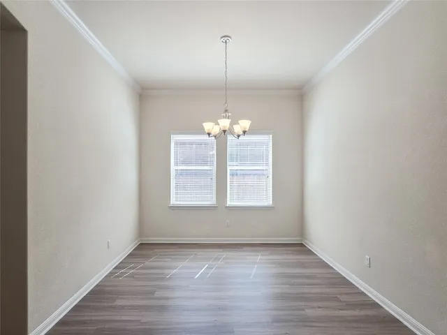 a view of a room with wooden floor and windows