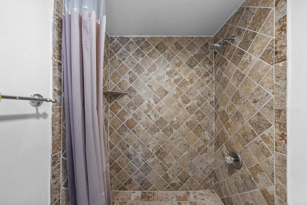 30265 Miller Road Valley Center, CA 92082 - Photo 28 of 56 a bathroom with a shower curtain
