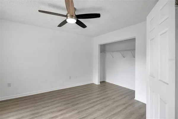 a view of a room with wooden floor