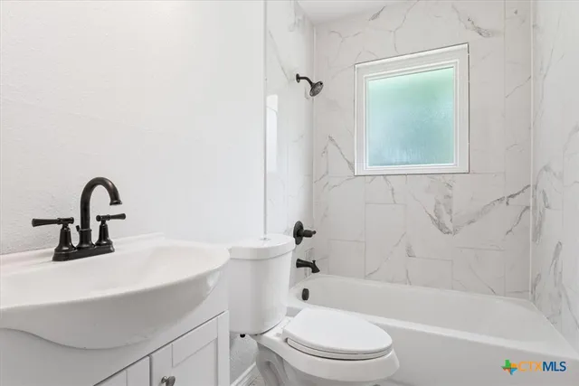 a bathroom with a sink a toilet and a bathtub