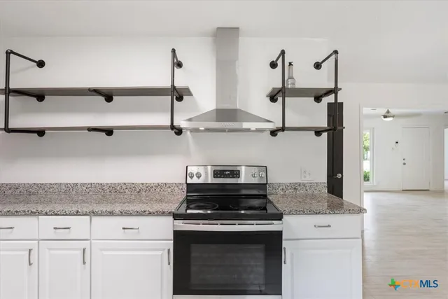 a stove top oven sitting inside of a kitchen