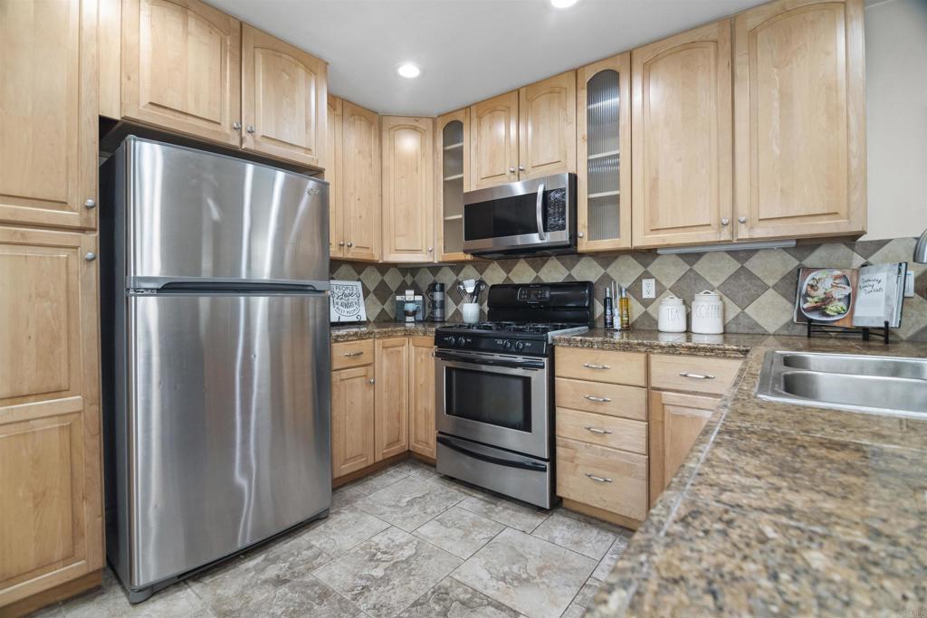178 Elder Avenue Imperial Beach, CA 91932 - Photo 7 of 26 a kitchen with white cabinets stainless steel appliances and a sink