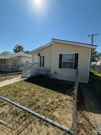 a view of a house with wooden fence