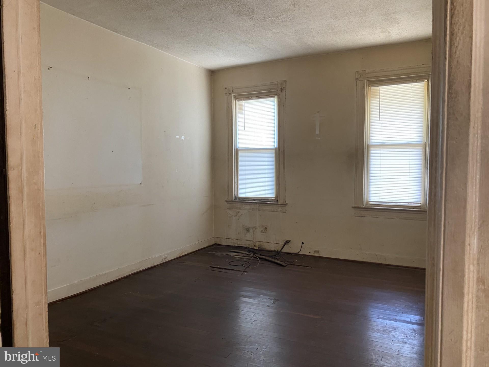2802 Mosher Street Baltimore, MD 21216 - Photo 6 of 6 an empty room with wooden floor and windows