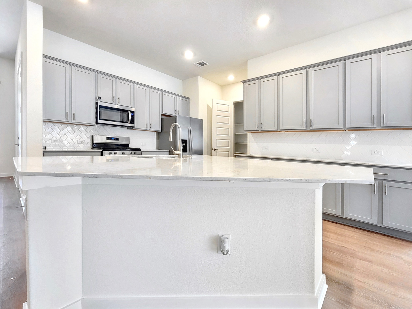 2329 Gabriels Horn Road Leander, TX 78641 - Photo 4 of 23 Culinary delights await in this modern kitchen, featuring sleek countertops and ample storage.