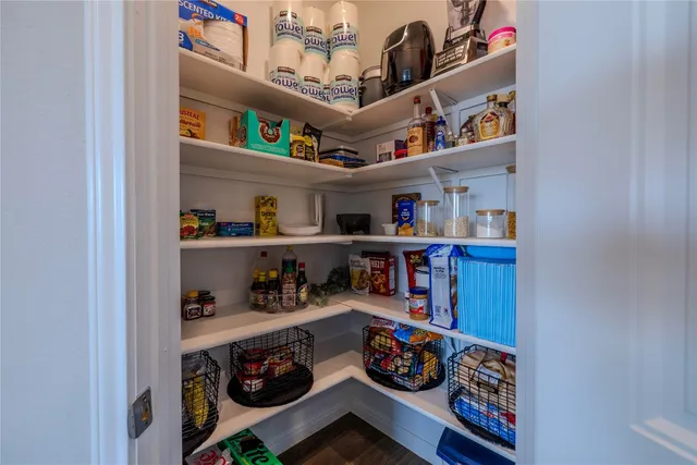 a kitchen with a table chairs microwave and refrigerator