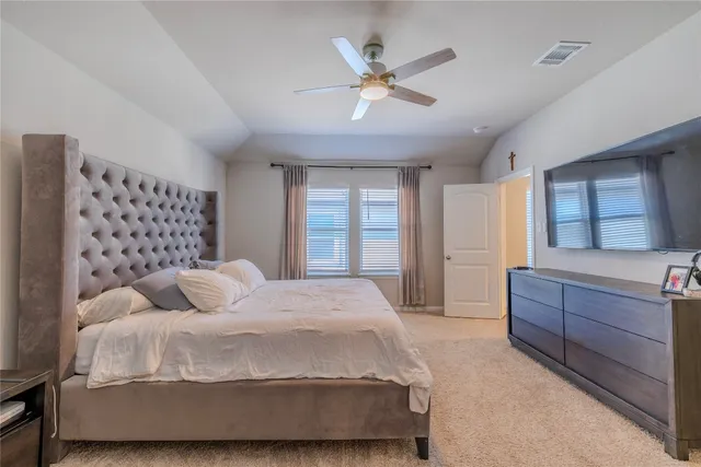 a bedroom with a bed dresser and a window