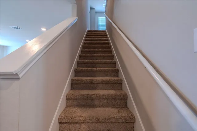 a view of walk in closet with clothes