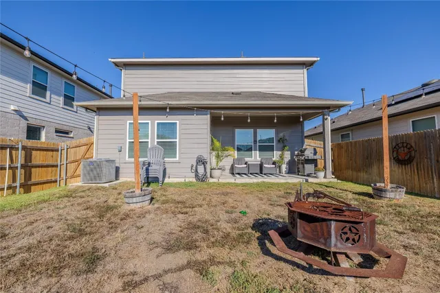 a view of a house with backyard and sitting area