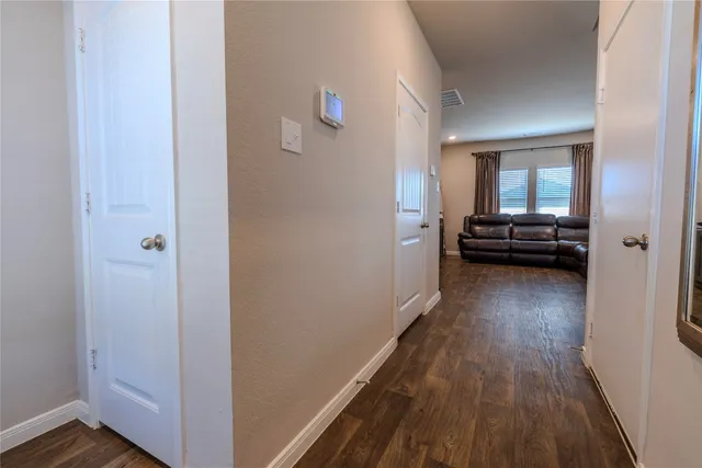 a view of a hallway view with wooden floor and furniture