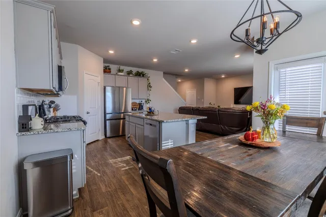 a kitchen with stainless steel appliances granite countertop sink stove top oven and cabinets