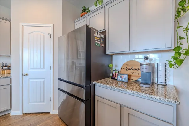 a stove top oven sitting inside of a kitchen and granite counter tops