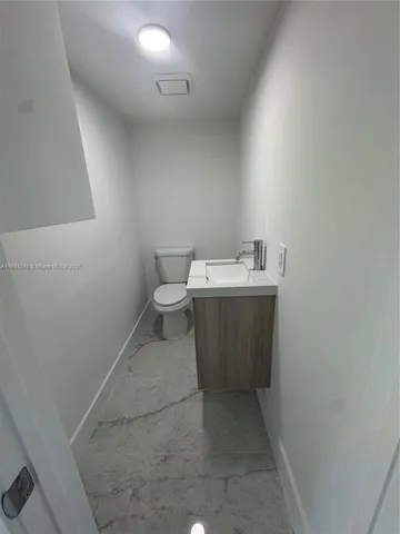 a bathroom with a sink toilet and mirror