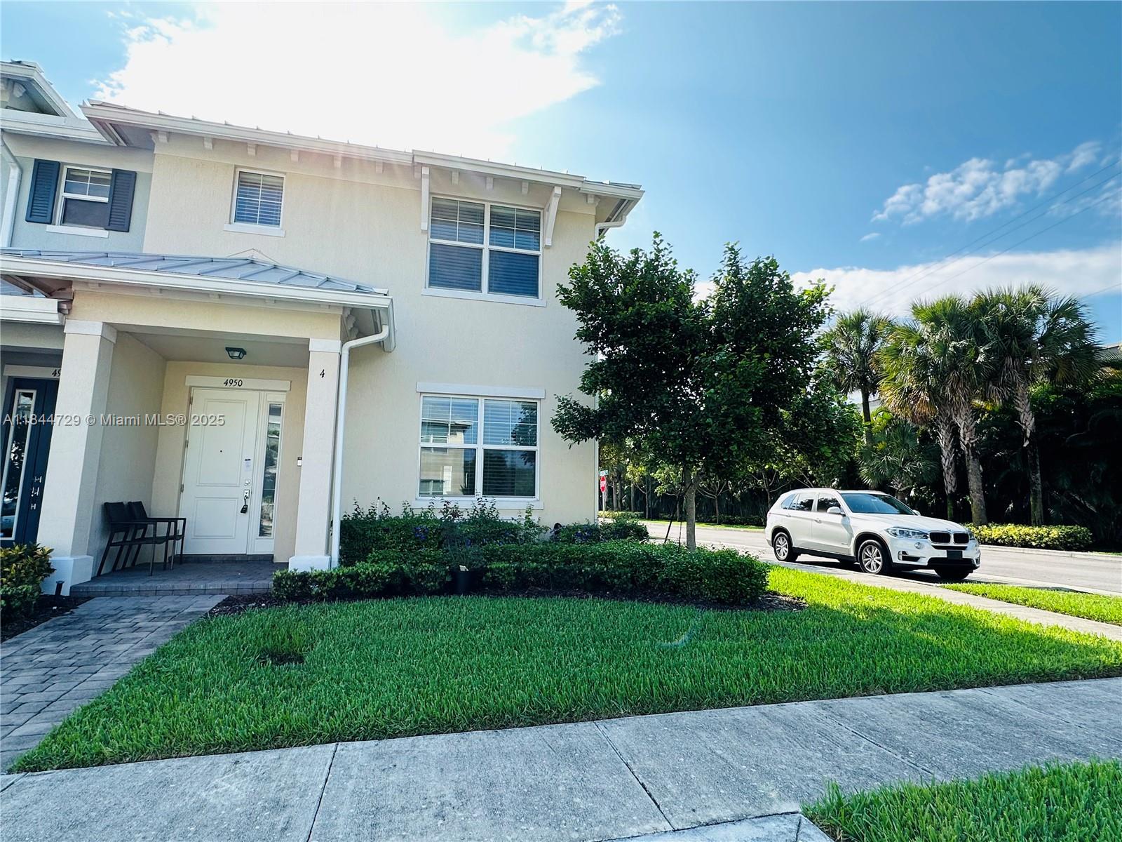 4950 Eucalyptus Drive, Unit 4 Hollywood, FL 33021 - Photo 1 of 25 a front view of a house with a yard