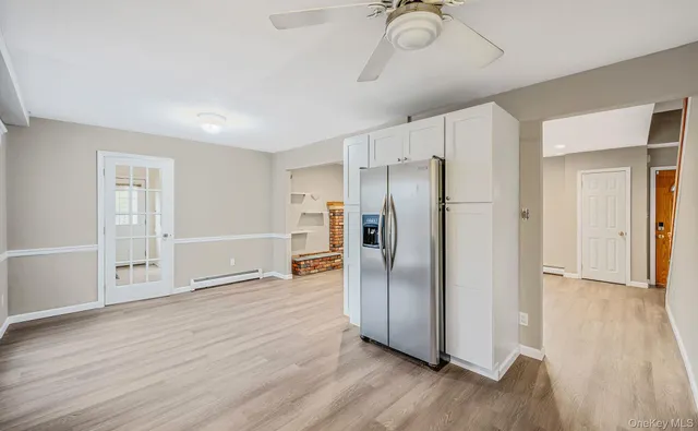a view of a room that has a bed wooden floor and closet area