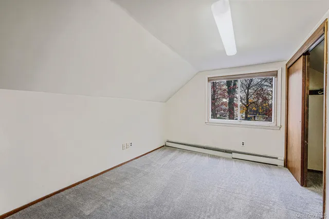 a view of an empty room with closet area