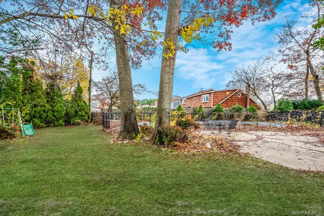 a backyard of a house with table and chairs