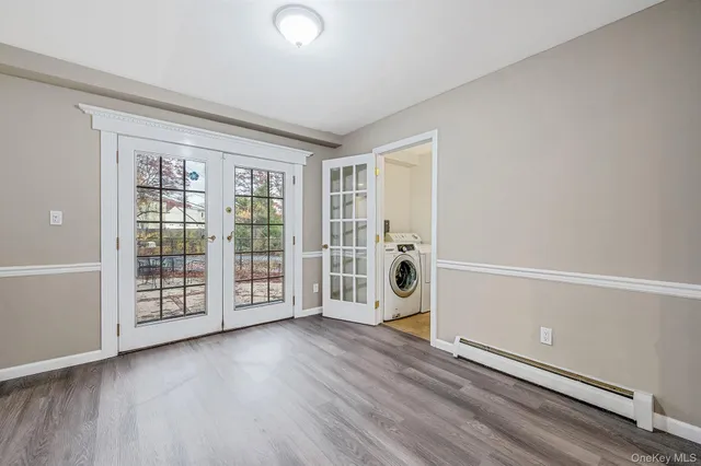 a living room with stainless steel appliances kitchen island granite countertop a refrigerator and a stove top oven