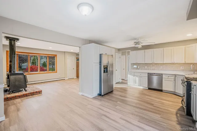a kitchen with a refrigerator stove top oven and cabinets