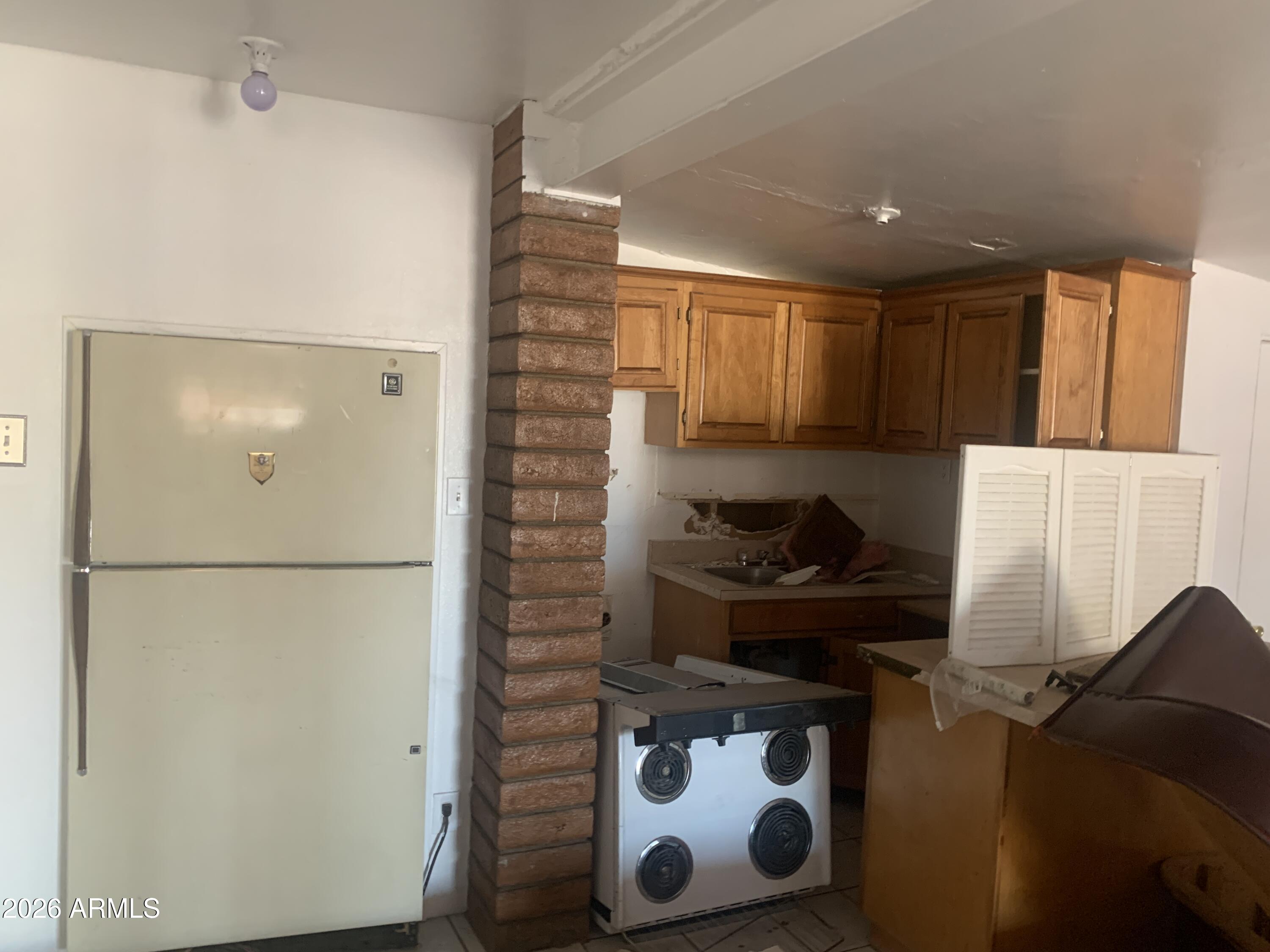 1202 South 14th Street Phoenix, AZ 85034 - Photo 24 of 44 a kitchen with a refrigerator and a stove