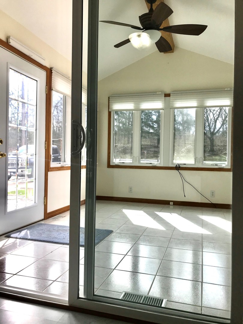 819 North 2803rd Road Utica, IL 61373 - Photo 14 of 19 a view of an empty room with a window and wooden floor