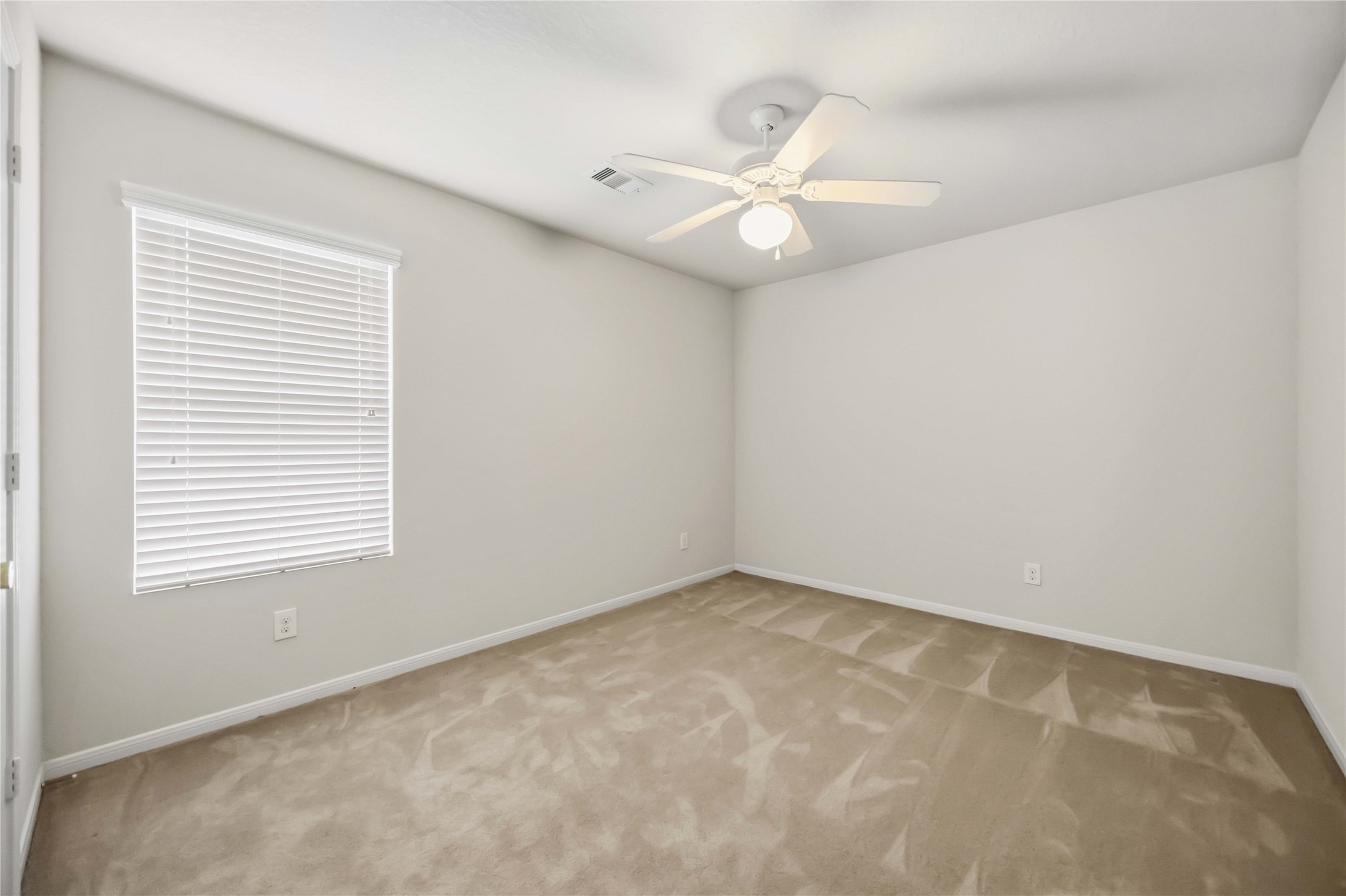 29526 Winton Wood Way Spring, TX 77386 - Photo 23 of 29 Alternate view of the secondary bedroom, all rooms feature ceiling fans, neutral finishes and walk-in closets.
